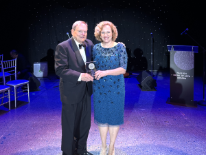 Jimmy Gilmore and Elizabeth Beilman holding award 