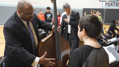 John Brown showing his bass to students