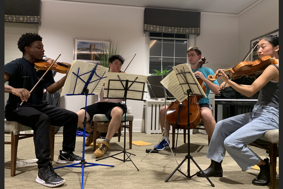 Four students performing in a string quartet