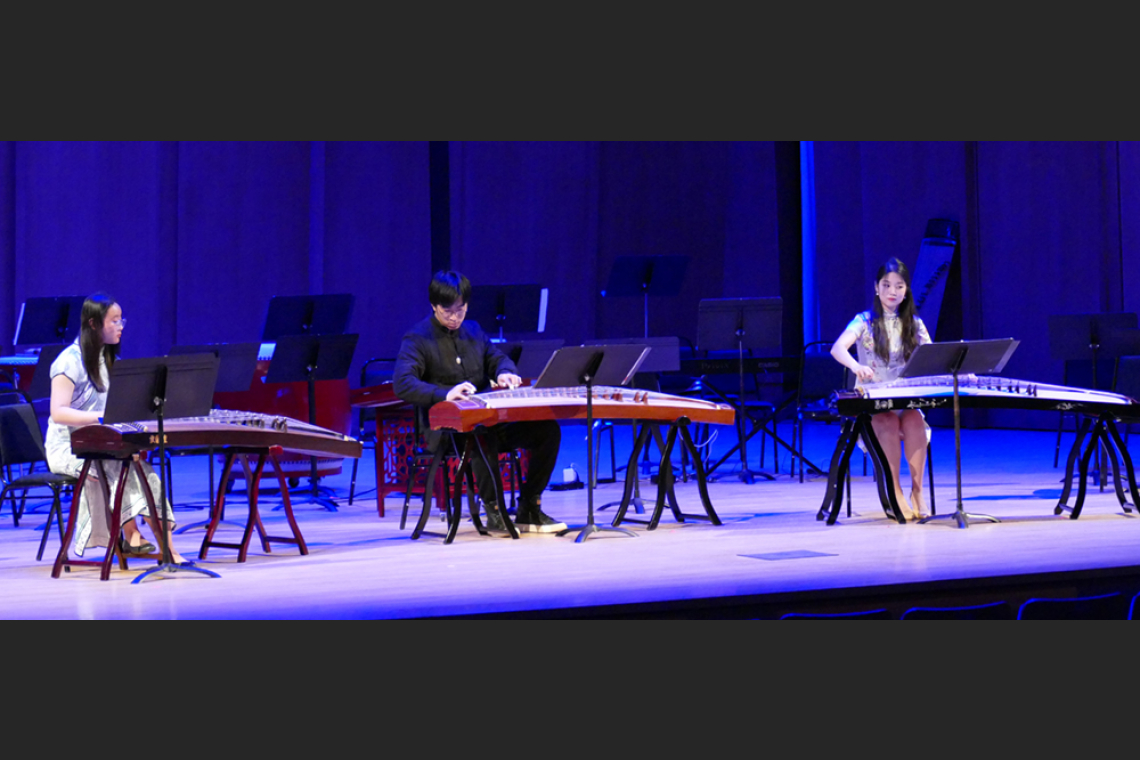 3 guzheng performers on stage