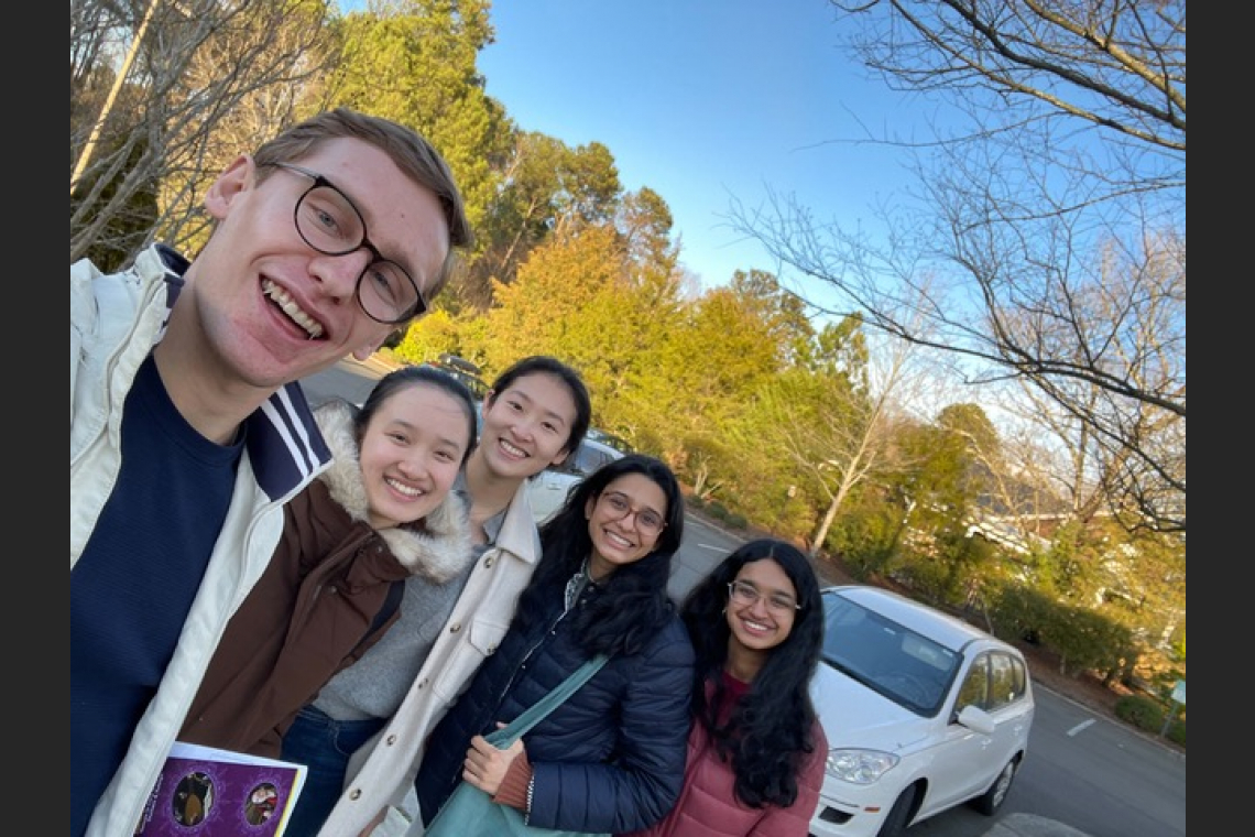 Five students standing in a parking lot